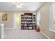 Bedroom with a large wooden bookcase filled with books and natural light from a window at 6211 W Bayfront Shores, McCordsville, IN 46055