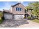 Brick home with a three-car garage, manicured landscaping, and symmetrical design at 6211 W Bayfront Shores, McCordsville, IN 46055