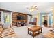 Comfortable living room with wood accent wall and large windows offering serene outdoor views at 6211 W Bayfront Shores, McCordsville, IN 46055