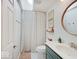Bathroom with a tiled shower and teal vanity at 6220 Yellow Birch Ct, Avon, IN 46123