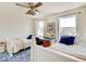 This bedroom features twin beds, a ceiling fan, natural light, and a beautiful area rug at 6220 Yellow Birch Ct, Avon, IN 46123