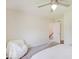 Bright bedroom features a ceiling fan, soft chair, neutral walls, and carpeted floors at 6220 Yellow Birch Ct, Avon, IN 46123