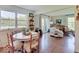 Charming dining area with hardwood floors, a round table, and a view into the spacious living room at 6220 Yellow Birch Ct, Avon, IN 46123