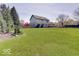 Exterior rear view of home featuring a large manicured lawn at 6220 Yellow Birch Ct, Avon, IN 46123