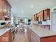 Open-concept kitchen features wood cabinets, granite countertops, and a view of the adjacent living area at 6220 Yellow Birch Ct, Avon, IN 46123