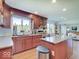 Bright kitchen featuring granite countertops, wood cabinets, and a view of the backyard at 6220 Yellow Birch Ct, Avon, IN 46123