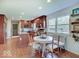 Well-lit kitchen with wood cabinetry, stainless steel appliances, and an adjacent dining area at 6220 Yellow Birch Ct, Avon, IN 46123