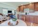 Kitchen with wooden cabinets and granite countertops is next to a living area with large windows at 6220 Yellow Birch Ct, Avon, IN 46123