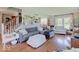 Cozy living room featuring hardwood floors, a large sectional sofa, and a gallery wall at 6220 Yellow Birch Ct, Avon, IN 46123