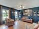 Living room with hardwood floors, a tufted leather sofa, and lots of natural light at 6220 Yellow Birch Ct, Avon, IN 46123