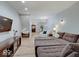 Spacious living room with plush sectional, hardwood floors, and open floor plan at 6220 Yellow Birch Ct, Avon, IN 46123