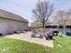 Back patio with ample seating, BBQ grill, and lush landscaping at 6220 Yellow Birch Ct, Avon, IN 46123