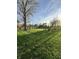 Expansive backyard with play equipment and a seating area around the fire pit at 6226 Fairlane Dr, Indianapolis, IN 46259