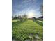 Expansive backyard featuring a well-maintained lawn, a seating area with chairs and a fire pit, and a storage shed at 6226 Fairlane Dr, Indianapolis, IN 46259