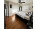 Bedroom with wood floors, a ceiling fan, and double-door closet at 6226 Fairlane Dr, Indianapolis, IN 46259
