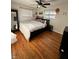 Comfortable bedroom with hardwood floors and a modern bed frame at 6226 Fairlane Dr, Indianapolis, IN 46259