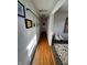 Hallway with wood flooring and art-lined walls leading to other rooms at 6226 Fairlane Dr, Indianapolis, IN 46259