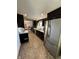 Well-equipped kitchen with a stainless steel refrigerator and dark cabinetry at 6226 Fairlane Dr, Indianapolis, IN 46259
