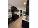 Long, spacious kitchen with dark cabinets and stainless steel appliances at 6226 Fairlane Dr, Indianapolis, IN 46259