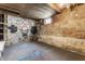 Unfinished basement featuring concrete walls with graffiti art and blue painted floor markings at 637 Berkley Rd, Indianapolis, IN 46208