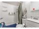 Bright bathroom with a shower-tub combo, featuring white tiles, a vanity, and modern fixtures at 637 Berkley Rd, Indianapolis, IN 46208