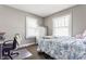 Cozy bedroom with natural light, featuring a blue floral bedspread, desk, and two windows at 637 Berkley Rd, Indianapolis, IN 46208