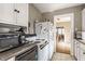 Kitchen featuring white appliances, grey countertops, and a view to the adjacent dining area at 637 Berkley Rd, Indianapolis, IN 46208