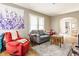 Bright living room with a cozy sitting area, large window, and an open archway to the dining room at 637 Berkley Rd, Indianapolis, IN 46208