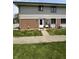 Inviting front entrance featuring a brick facade and well-maintained lawn at 6458 Lupine Ter, Indianapolis, IN 46224