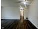 Open-concept living room with hardwood floors and modern lighting fixtures at 6458 Lupine Ter, Indianapolis, IN 46224