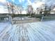 Backyard featuring a pool with a safety cover, surrounded by a wooden deck and mature trees at 7121 Fields Way, Indianapolis, IN 46239