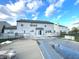 A spacious backyard view shows a covered pool, patio and the home's exterior at 7121 Fields Way, Indianapolis, IN 46239