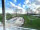 Backyard view featuring an in-ground pool with a safety cover, surrounded by a lush green lawn at 7121 Fields Way, Indianapolis, IN 46239