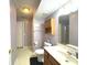 Cozy bathroom features a single vanity with a mirror, a toilet, cabinet, and a shower and tub combination at 7121 Fields Way, Indianapolis, IN 46239