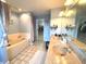 Bathroom featuring double sinks, a bathtub with shower, and a walk-in closet at 7121 Fields Way, Indianapolis, IN 46239