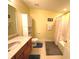 The bright bathroom features a single sink vanity, commode, cabinet, and shower/tub combination at 7121 Fields Way, Indianapolis, IN 46239