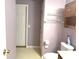 Cozy lavendar bathroom featuring a toilet and vanity with laminate flooring at 7121 Fields Way, Indianapolis, IN 46239