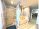 Bathroom featuring a glass-enclosed shower, a bathtub, and tile flooring, perfect for relaxation at 7121 Fields Way, Indianapolis, IN 46239