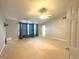 Bright bedroom with a ceiling fan, neutral walls, and large window with elegant curtains at 7121 Fields Way, Indianapolis, IN 46239
