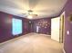 Spacious bedroom with a ceiling fan, a window with blinds, and a mirror on the wall at 7121 Fields Way, Indianapolis, IN 46239