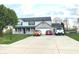 Charming two-story home featuring a brick-accented facade, attached garage, and well-manicured lawn at 7121 Fields Way, Indianapolis, IN 46239