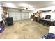 Spacious garage with a roll-up door, workbench, and ample storage space for tools and equipment at 7121 Fields Way, Indianapolis, IN 46239