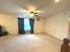 Bright living room with a ceiling fan, neutral carpet, and ample space for relaxation and entertainment at 7121 Fields Way, Indianapolis, IN 46239