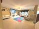 Spacious living room featuring a fireplace, ceiling fan, and carpeted floors at 7121 Fields Way, Indianapolis, IN 46239