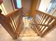 Carpeted staircase with wood railings leads to the upper level of the home, connecting living spaces at 7121 Fields Way, Indianapolis, IN 46239