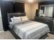 Comfortable bedroom with a gray finish, plush bedding, dresser, and ample natural light at 7206 Halden Pl, Indianapolis, IN 46214
