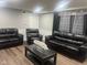 Spacious living room with leather seating, modern decor, and plenty of room for entertaining at 7206 Halden Pl, Indianapolis, IN 46214
