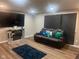 Modern living room featuring a comfortable leather sofa, sleek fireplace, and recessed lighting at 7206 Halden Pl, Indianapolis, IN 46214