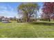 Picturesque backyard with a sprawling lawn, mature trees, and a gazebo, perfect for outdoor enjoyment at 7280 E Patricia Dr, Camby, IN 46113