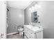 Practical bathroom with ample storage, sink, a toilet, and safety-assist bars at 7280 E Patricia Dr, Camby, IN 46113